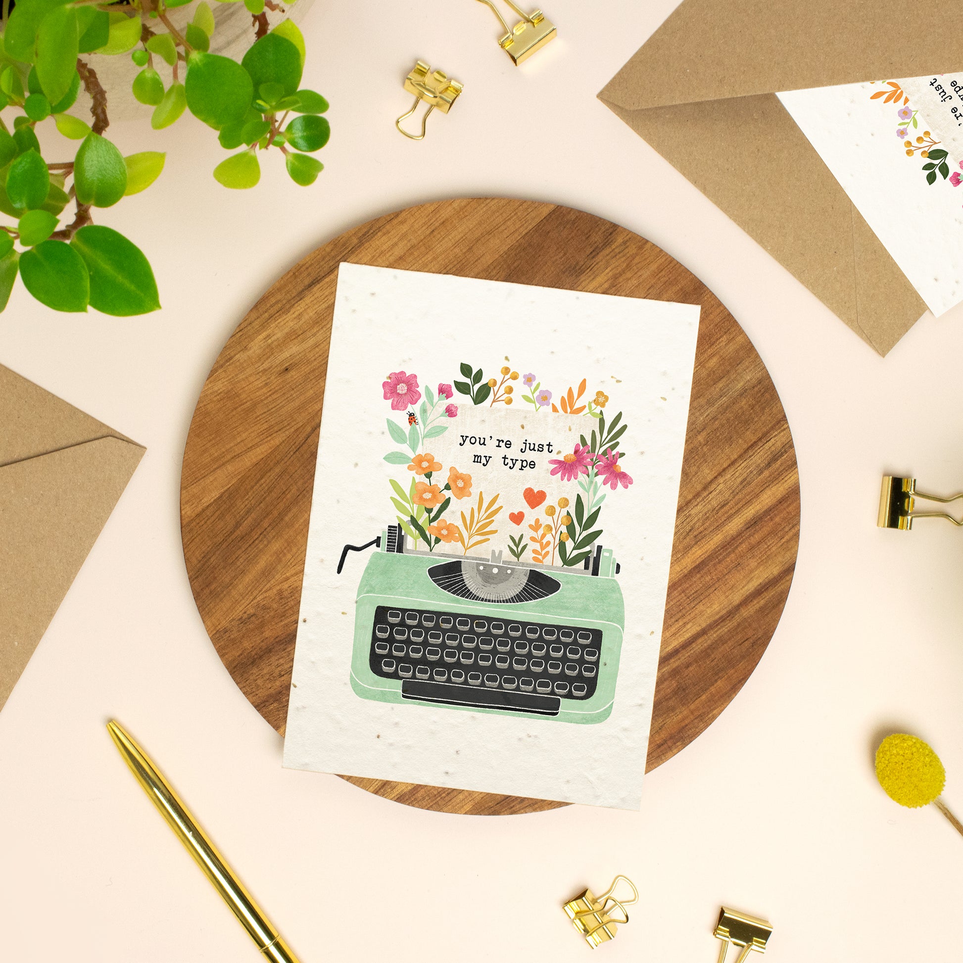 Plantable typewriter valentine's day card with wildflowers on a wooden board